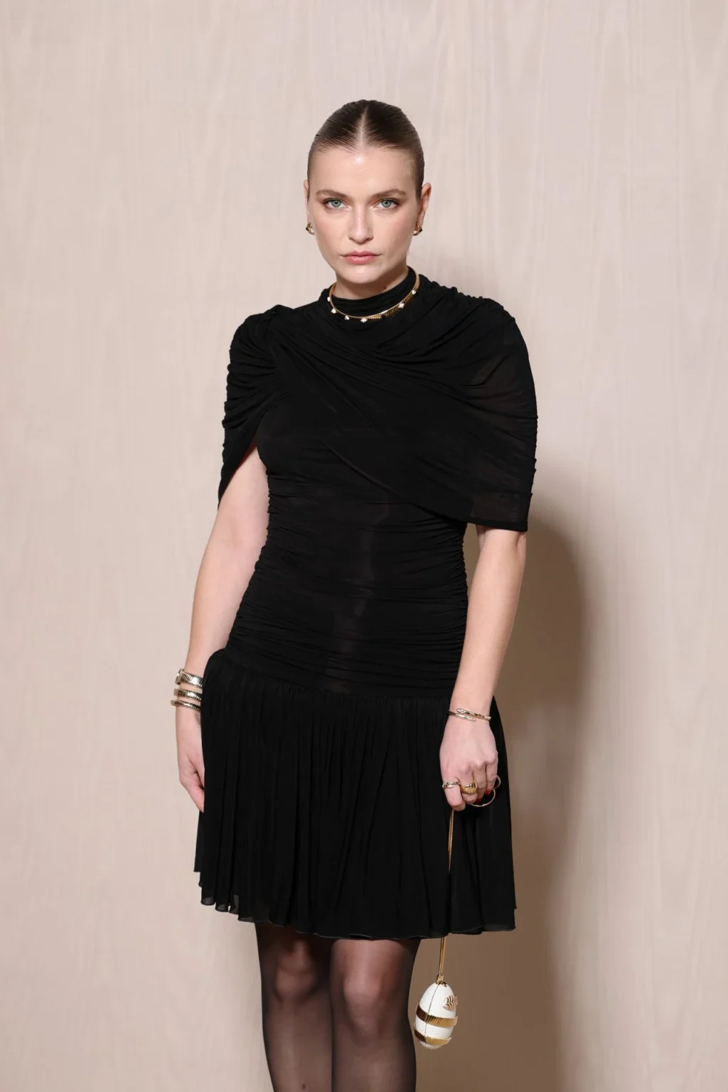 Camille Razat at Paris Fashion Week 2026 BVLGARI ICONS event in black dress