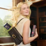 Elle Fanning reading with Coach Tabby bag spring 2026 campaign