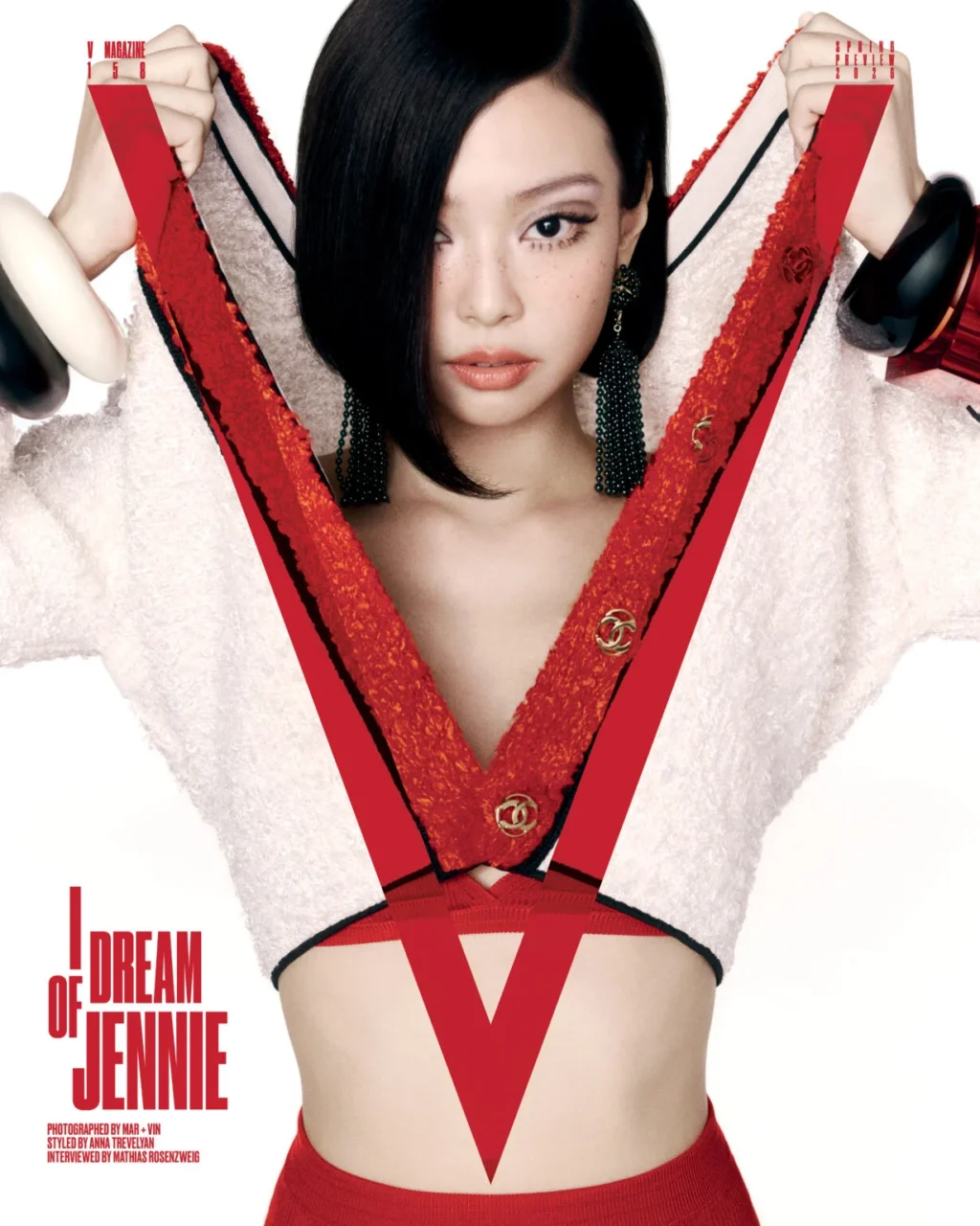 Jennie on the cover of V Magazine wearing a jacket, silk bra, and silk trunks