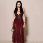 Pia Wurtzbach wearing a burgundy embellished gown at BVLGARI ICONS Minaudière celebration Paris 2026